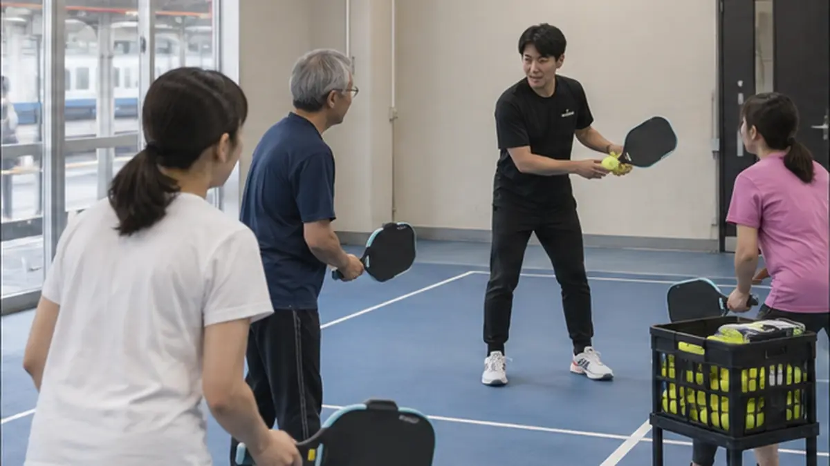 神奈川の屋内コートで初心者を指導するコーチ
